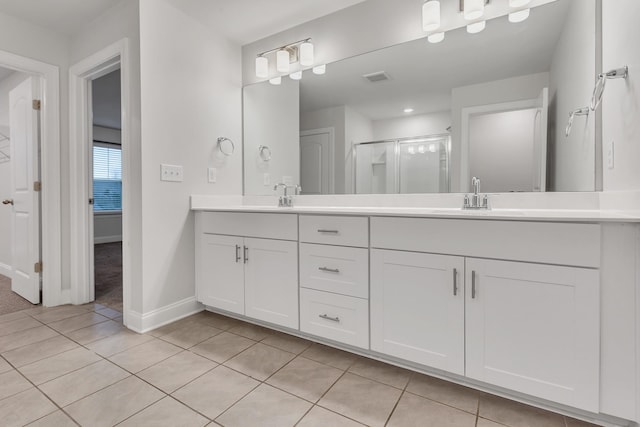 bathroom featuring walk in shower, tile patterned floors, and vanity