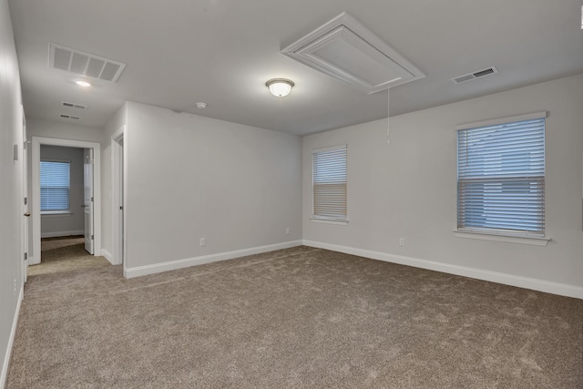 spare room featuring light colored carpet