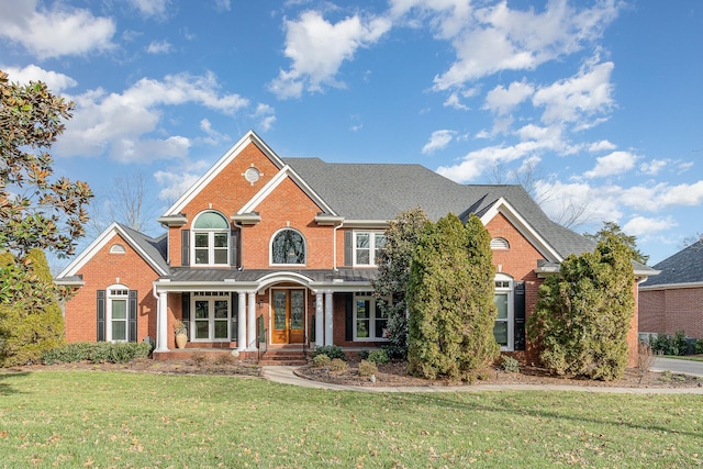 view of front of house with brick siding and a front yard