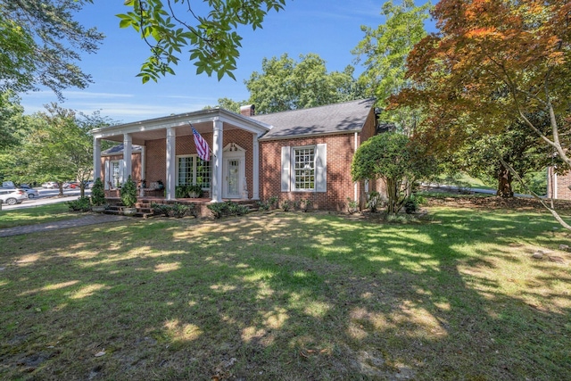 neoclassical home with a front yard and a porch