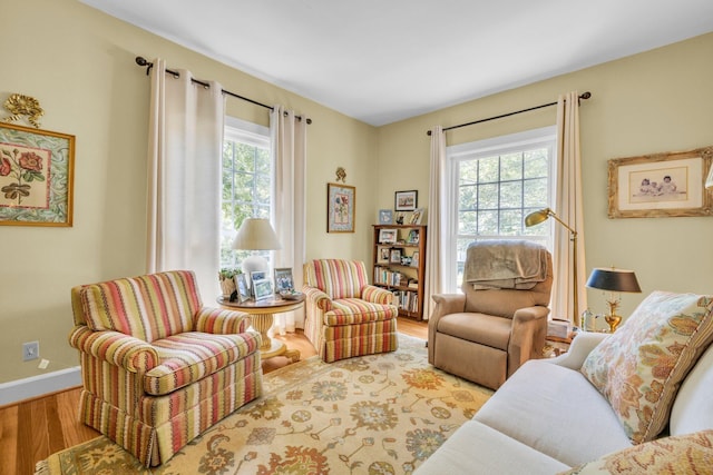 living area featuring plenty of natural light and light hardwood / wood-style floors