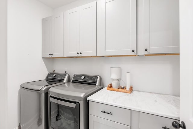 washroom with cabinets and independent washer and dryer