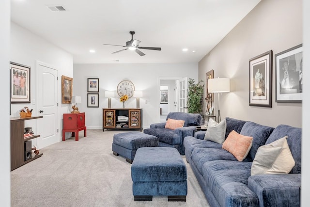 living room featuring ceiling fan and light colored carpet