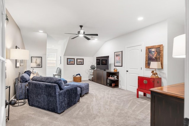 living room featuring lofted ceiling, light colored carpet, and ceiling fan