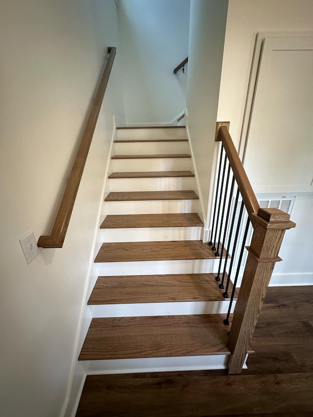 stairs featuring hardwood / wood-style flooring