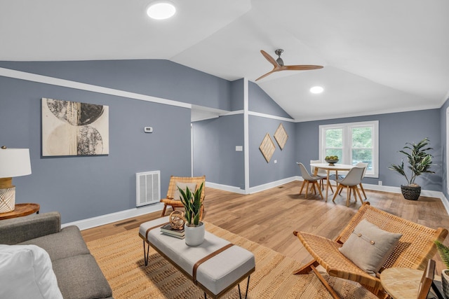 living room featuring vaulted ceiling, ceiling fan, and light hardwood / wood-style floors