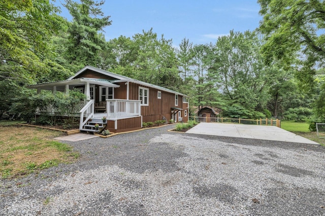 view of front facade with a deck and a sunroom