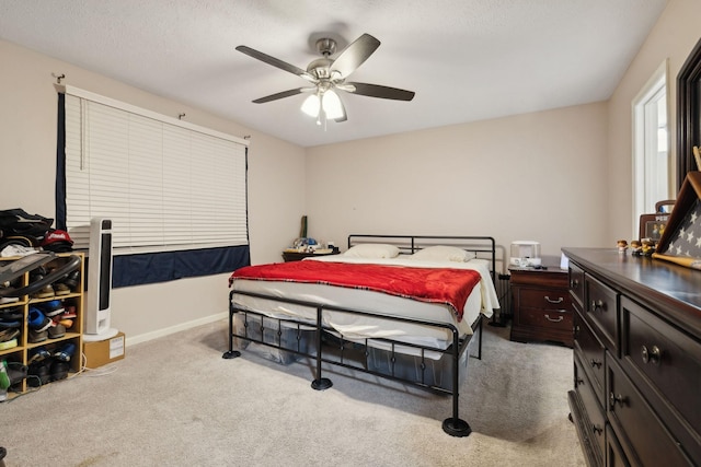 carpeted bedroom with a textured ceiling and ceiling fan