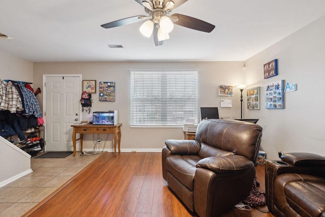 sitting room with ceiling fan and light hardwood / wood-style floors