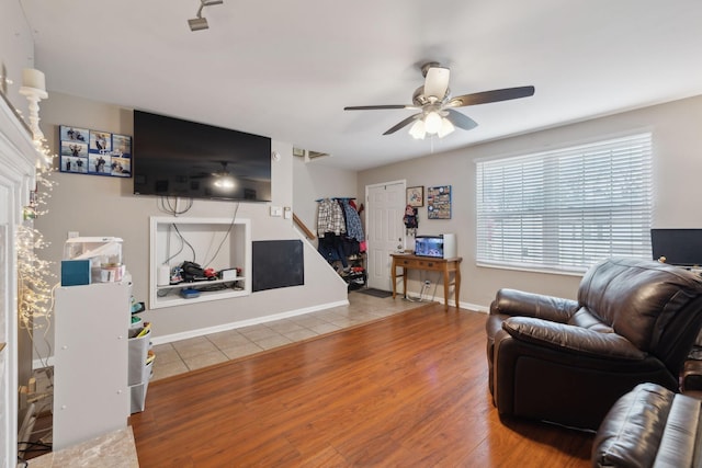 living room with ceiling fan and wood-type flooring