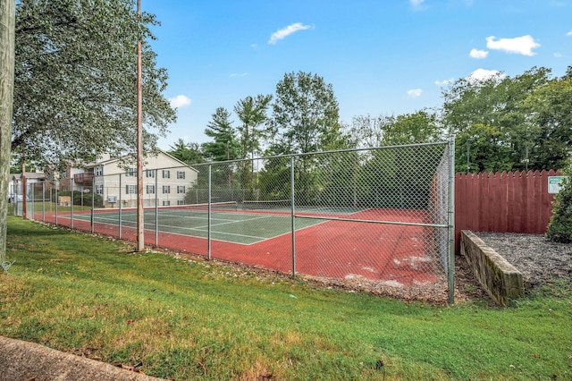 view of sport court with a yard