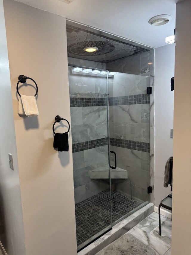 bathroom featuring a shower with shower door