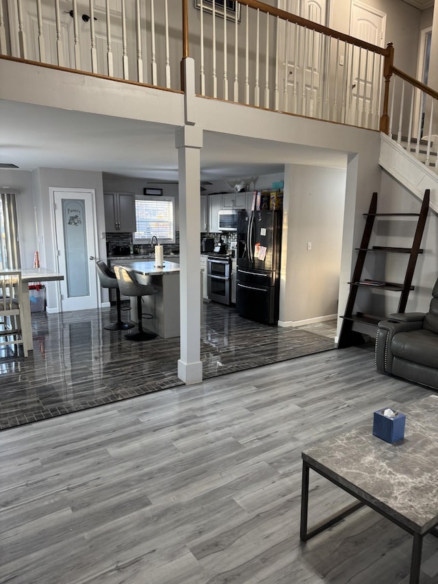 living room with a high ceiling and light hardwood / wood-style floors