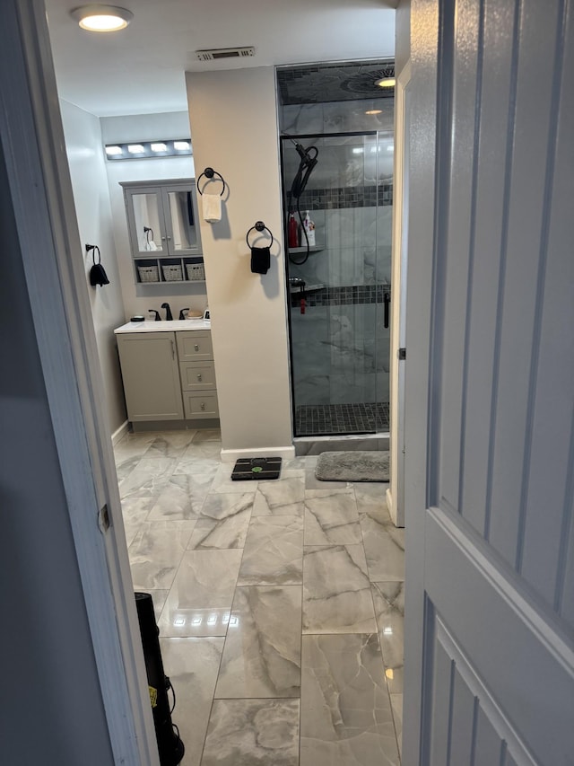 bathroom featuring walk in shower and vanity