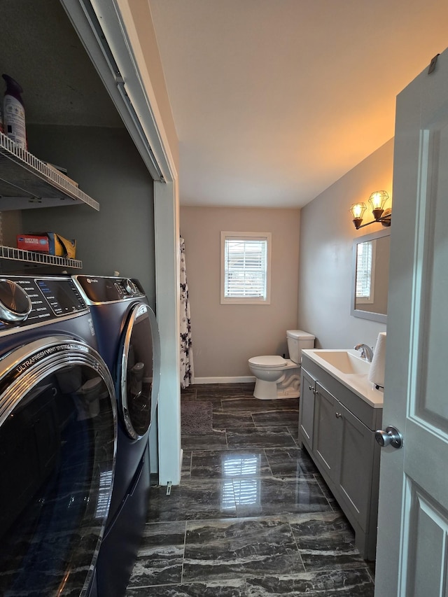 laundry area with sink and independent washer and dryer