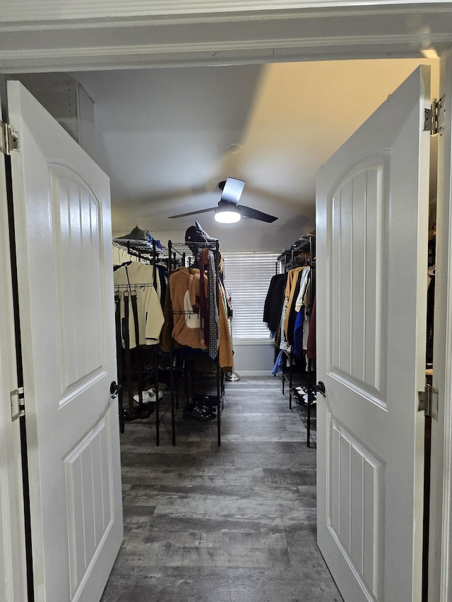 spacious closet with dark wood-type flooring and ceiling fan