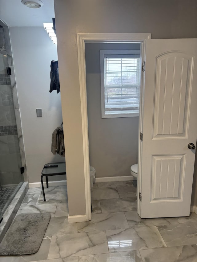 bathroom featuring toilet and walk in shower