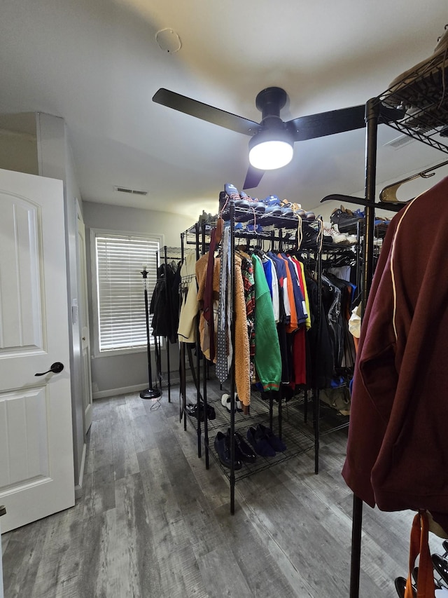 walk in closet with wood-type flooring and ceiling fan