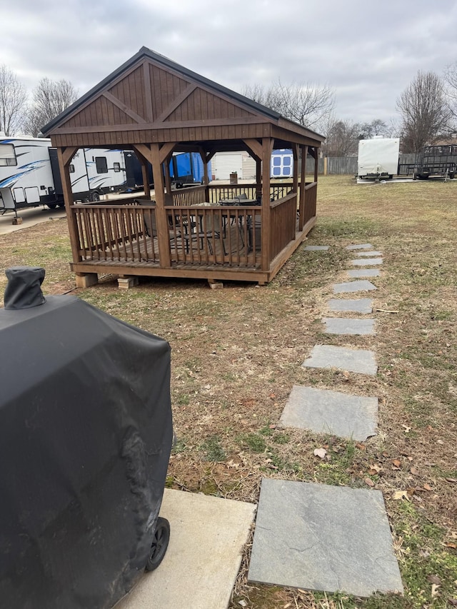 wooden deck featuring a gazebo, area for grilling, and a lawn