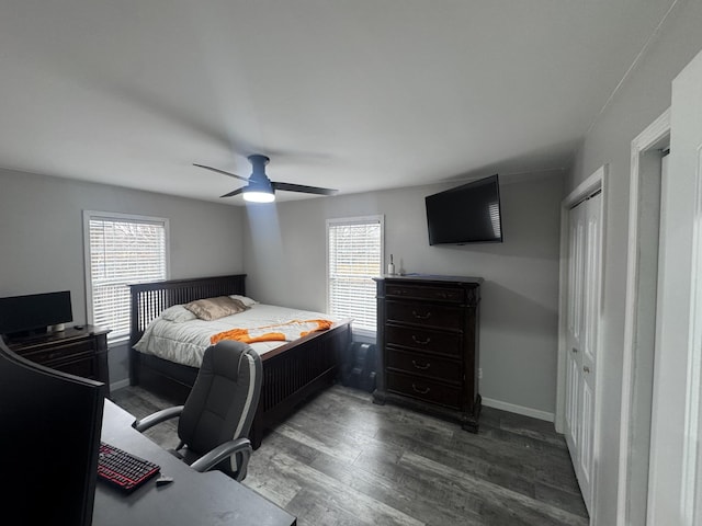 bedroom with dark wood-type flooring, ceiling fan, and multiple windows