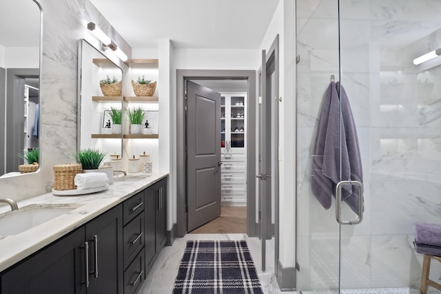 bathroom featuring vanity and an enclosed shower