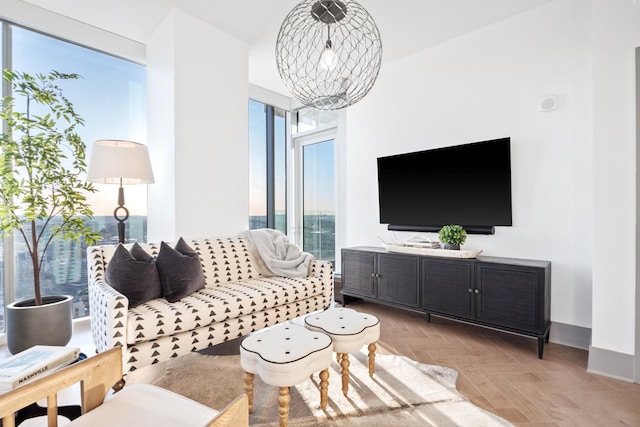 living room with a notable chandelier and light parquet floors