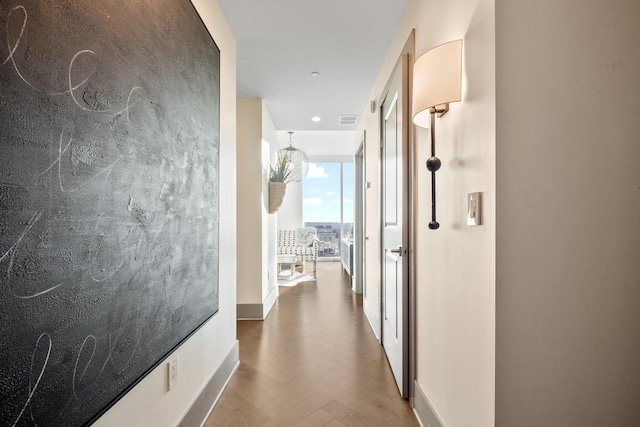 corridor featuring floor to ceiling windows and parquet floors