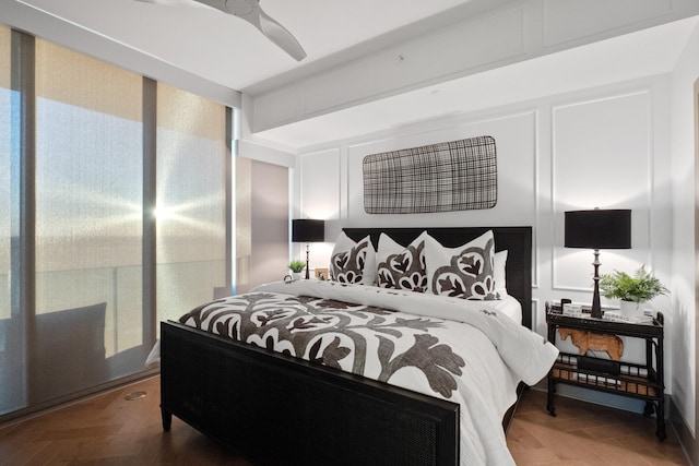 bedroom with ceiling fan and parquet flooring