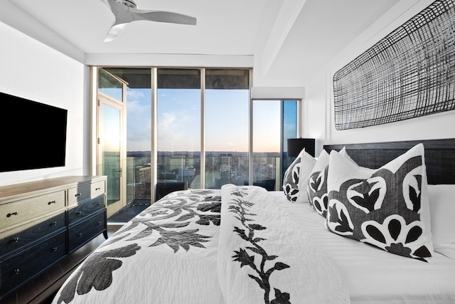 bedroom with access to exterior, a wall of windows, and ceiling fan