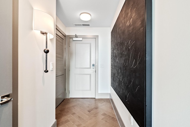 doorway to outside featuring light parquet floors