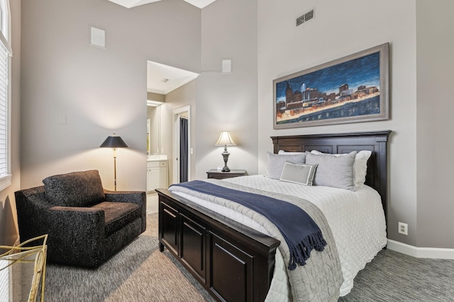 bedroom with carpet floors and a high ceiling