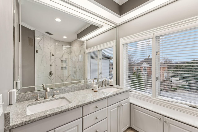 bathroom with vanity and a shower with shower door