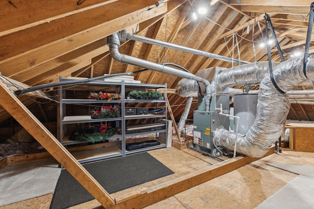 unfinished attic featuring water heater and heating unit