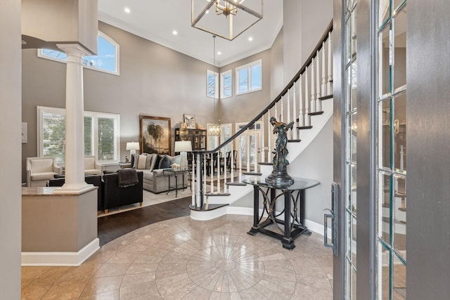 entrance foyer featuring a healthy amount of sunlight and ornate columns