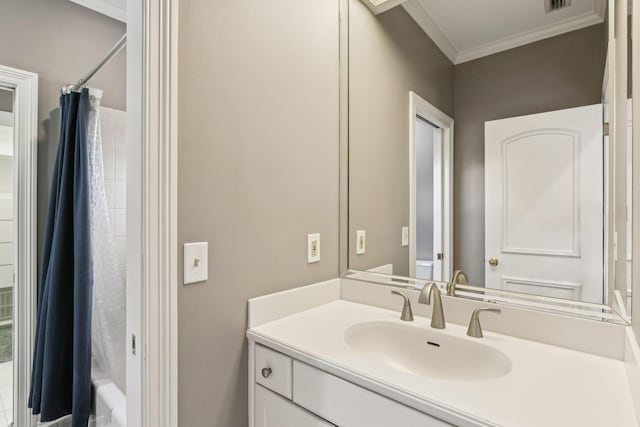 bathroom with vanity, crown molding, and shower / bath combo