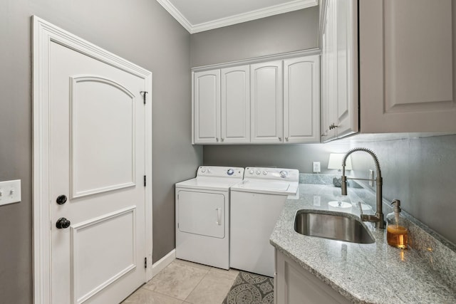 washroom with sink, light tile patterned floors, cabinets, ornamental molding, and separate washer and dryer