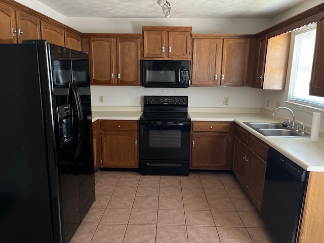 302 Plymouth Rock Ct, Madison, TN 37115 - kitchen featuring light tile patterned floors, sink, a textured ceiling, and black appliances