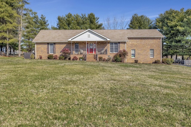 single story home with central AC unit, covered porch, and a front yard