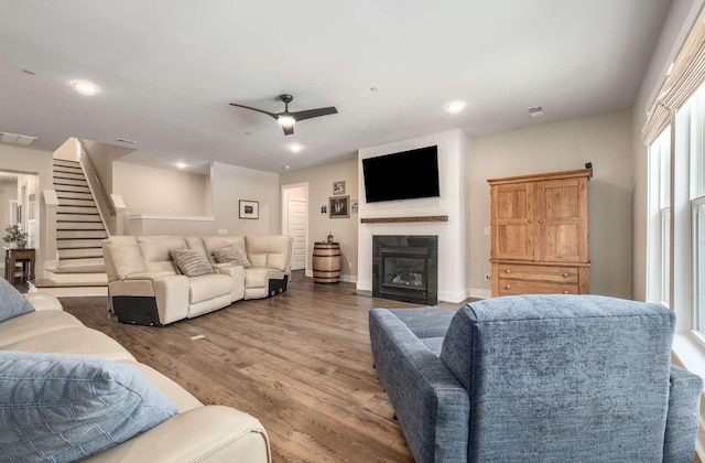 living room with wood-type flooring and ceiling fan