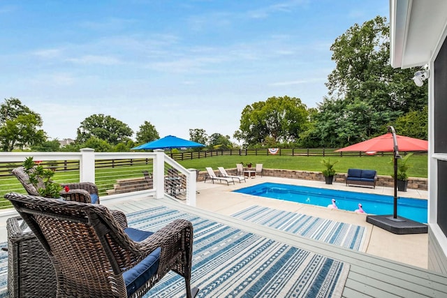 view of pool with an outdoor living space and a yard