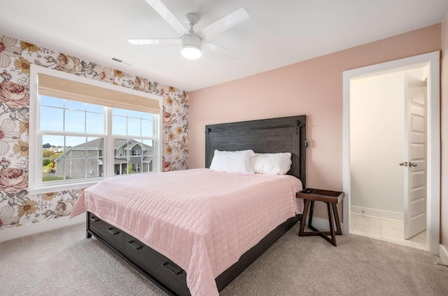 bedroom with light carpet and ceiling fan