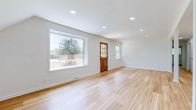 interior space featuring lofted ceiling and light hardwood / wood-style flooring