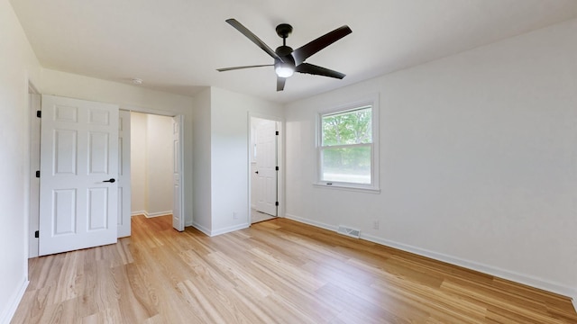 unfurnished bedroom with ceiling fan and light wood-type flooring