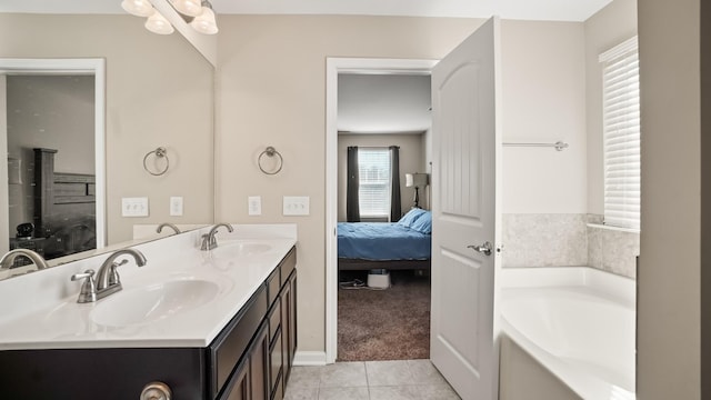 bathroom featuring tile patterned floors, a bathtub, and vanity