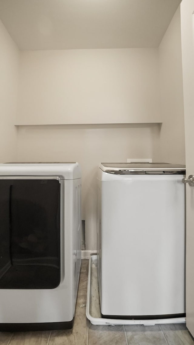 clothes washing area featuring washer and clothes dryer