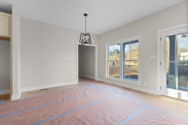 unfurnished dining area featuring light wood-style floors and baseboards