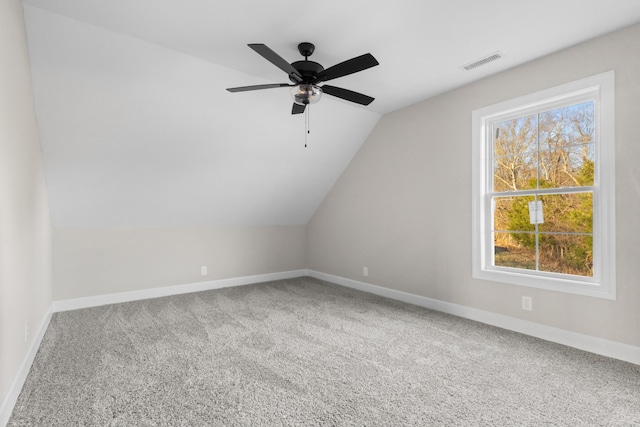 bonus room with lofted ceiling, baseboards, visible vents, and carpet flooring