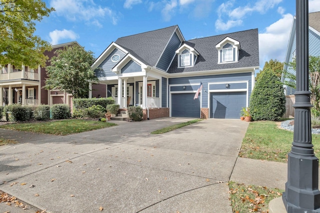 view of front of property with a garage, a front yard, and a porch