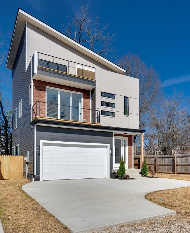 modern home featuring a garage and a balcony