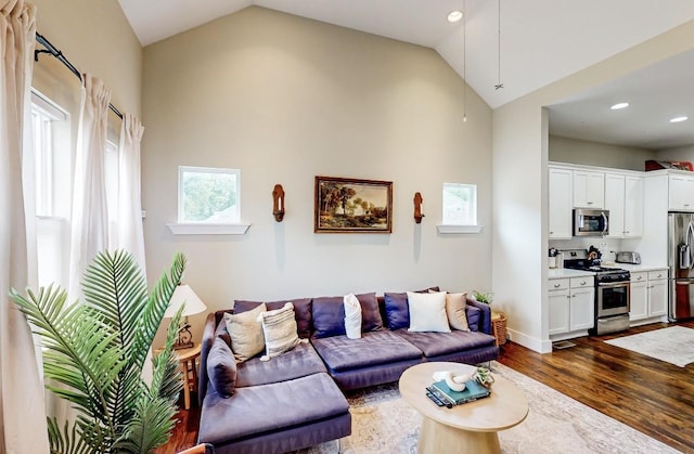 living room with vaulted ceiling and dark hardwood / wood-style floors